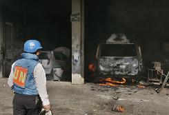 <FONT size=1>
<P>A United Nations worker surveys the damage from Israeli bombardment at the United Nations headquarters Jan. 15 in Gaza City.</P></FONT>