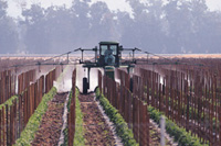 Spraying crops with chemicals