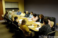 Photograph of people meeting at a conference table