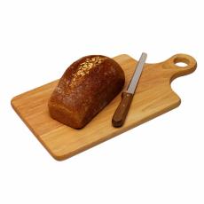 Photograph of a loaf of wheat bread on a cutting board