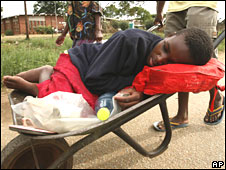 Zimbabwe cholera patient in wheelbarrow 