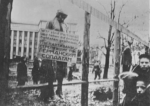 A hanged Jewish partisan with a sign stating, 