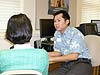 Attorney Tony Tran assists a client in filling out complex U.S. naturalization forms.