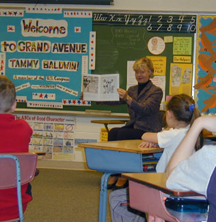 Photo: Tammy shares a good book with 3rd graders in Prairie du Sac.