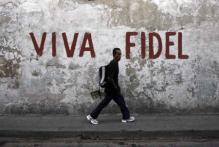  A man walks past a graffitti that reads "Long live Fidel" in Santiago de Cuba 