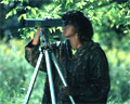 woman birding with a spotting scope