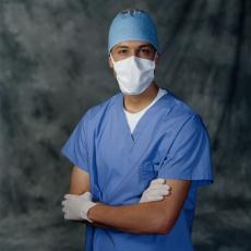 Photograph of a male surgeon in a surgical mask