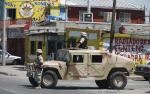 Soldiers guard a crime scene after a man was gunned down inside his shop in the border city of Ciudad Juarez August 22, 2008.