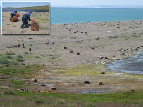 photo showing field full of barrels with inset photo of three men rolling barrels