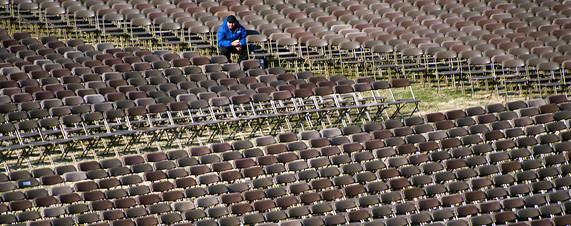[A lone man sits in the thousands of empty seats on the US Capital grounds for the presidential inauguration on January 12, 2009 in Washington, DC. President-elect Barack Obama will be sworn in as the 44th president of the US on January 20.]