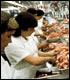 Workers in meat-processing plant.