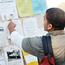 Male Student Looking At Bulletin Board