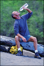 Photo: A man drinking bottled water