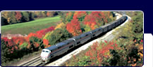 Passenger train traveling through New England, autumn
landscape.