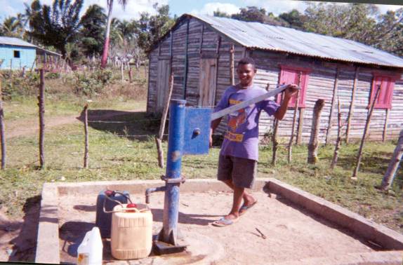 Child getting water at well
