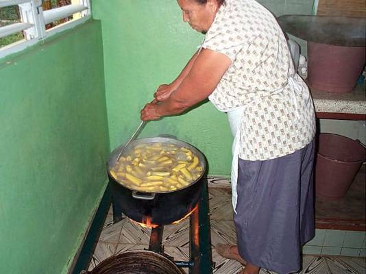 Woman cooking on small caulderon