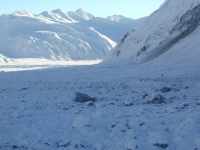 Ground Photo of the Fault: Landslide debris on the west fork of the Gakona Glacier. Note helicopter on right for scale! View to east. (AK, USA)