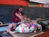 Photo of teacher William Leacock staging a physics experiment that demonstrates inertia and force distribution