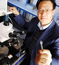 photo of researcher holding a prototype nanogenerator