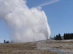 Old Faithful Erupting: Photograph of the Old Faithful Geyser erupting in Yellowstone Nationl Park. Old Faithful was named in 1870 during the Washburn-Langford-Doane Yellowstone expedition and was the first geyser in the Park to be named. (Yellowstone National Park, WY, USA)