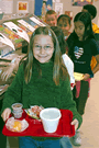 Little girl carrying her lunch tray