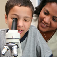 Student looking into microscope