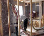Workers putting in cellulose insulation