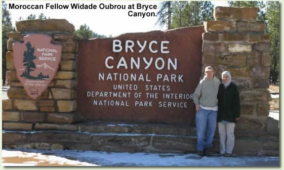 Moroccan intern Widade Oubrou at the Bryce Canyon NP entrance sign.