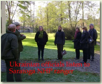 A group of Ukranian officials listen to a ranger talk at Saratoga NHP.