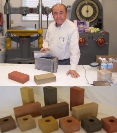 man at table in laboratory with equipment and samples of bricks