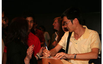 Photo of Terry Tao signing autographs for students at Thomas Jefferson High School, Arlington, Va.