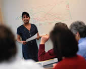 woman giving presentation at whiteboard