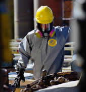 worker wearing respirator and chemical protective clothing