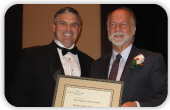 ASHA President David Wiley (l) presents the William A. Howe Award to Douglas Kirby.