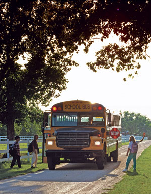 photo: children boarding a school bus