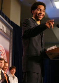 Jason presenting at Howard on stage, pointing into the audience