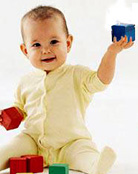 Image of a baby playing with blocks