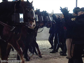 Police and horses practice crowd control techniques on Wednesday.