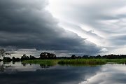 A storm front traveling north-east up the Likouala-aux-Herbes River, in the northern Congo Republic.