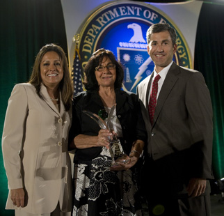 Director of the Office of Small Business Theresa Speake, with Associate Director Adrienne Cisneros, receives an award from Acting Deputy Secretary Jeff Kupfer for her work with small businesses at the DOE’s Small Business Conference in San Antonio. 