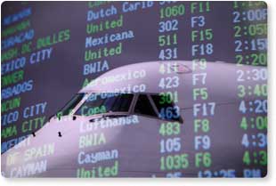 [PHOTOGRAPH] An airplane reflected in an airport's Departures board.