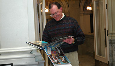 Bob Thomasgard views a scrapbook presented to him at his retirement celebration on January 9 that documents his 25-year tenure as associate director of the Wisconsin Historical Society.