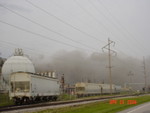 Smoke plume from chemical plant explosion, Illiopolis; vinyl chloride tanks in foreground.