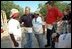 President Bush and Secretary for Housing and Urban Development Martinez, right, talk with new friends during a break from their house-building efforts at the Waco, Texas, location of Habitat for Humanity's "World Leaders Build" construction drive August 8, 2001. 