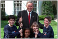 President George W. Bush meets with youth volunteers on the South Lawn of the White House. 