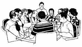 Image of a support group sitting around a table.