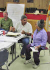 Photograph of Watson Castillo, local project pronent and member of Ojo Encino Ranchers Committee, discusses solid waste survey with Ojo Encino resident