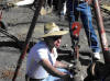 Photograph of Gregory Fenchel demostrates beaver auger to determine ground water depth