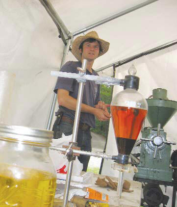 Dorn Cox with his sunflower seed press and sunflower oil