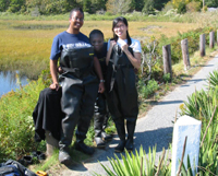 Leonora, Ida and June in waders preparing to survey the Weir Creek Salt Marsh.